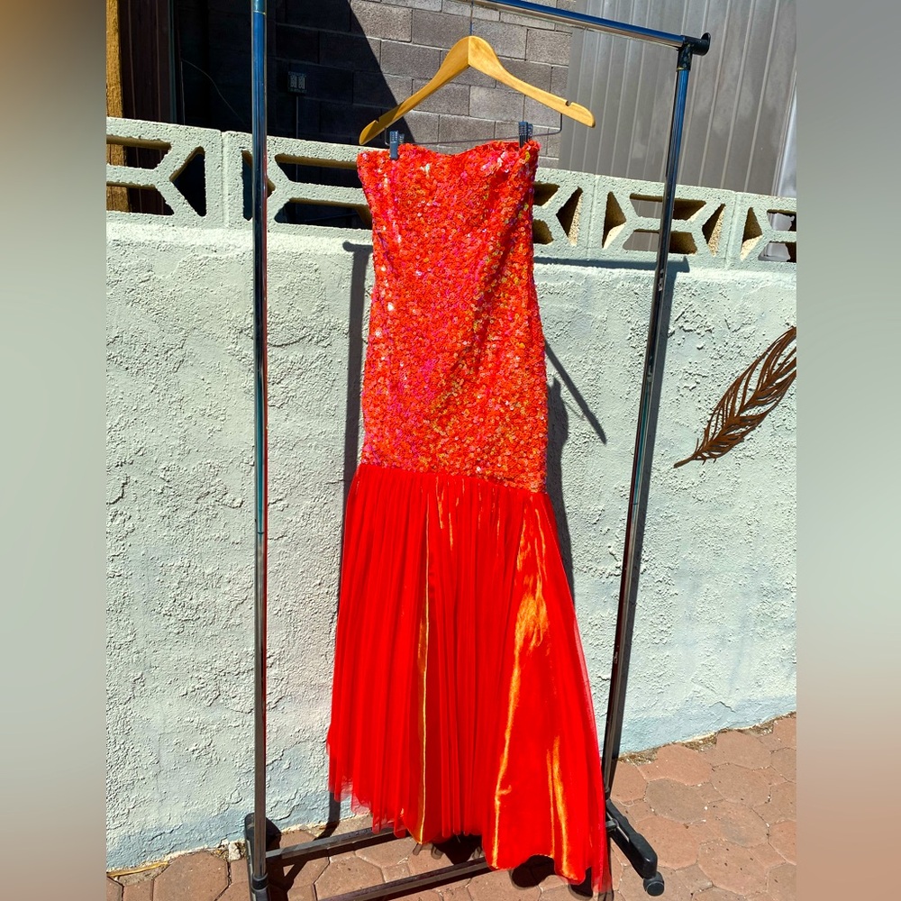 Orange iridescent strapless long gown.
